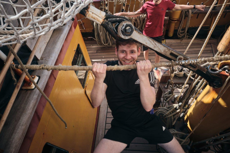 Catching up a fair breeze under full sail over calm seas by Richard Simko