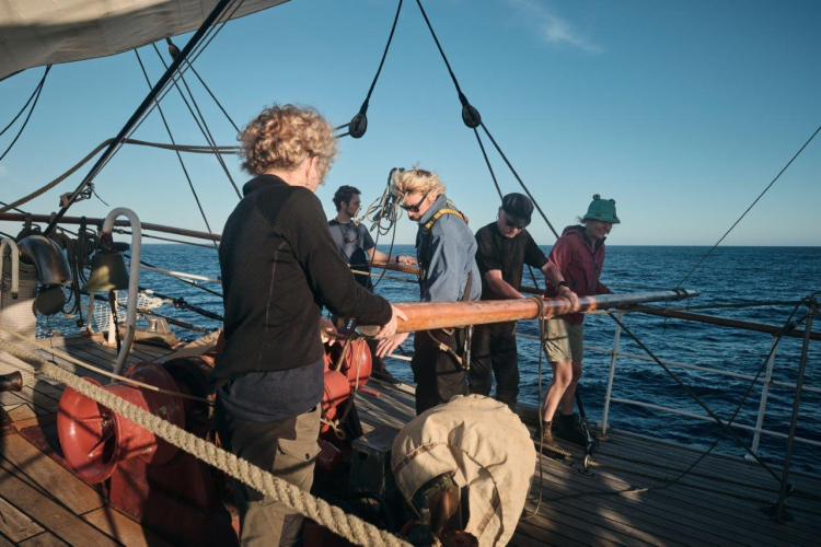 Catching up a fair breeze under full sail over calm seas by Richard Simko