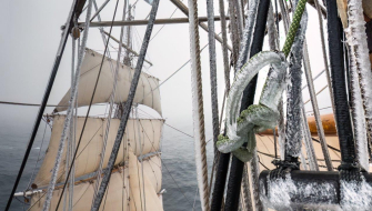 A view from aloft showing icy rigging and sails