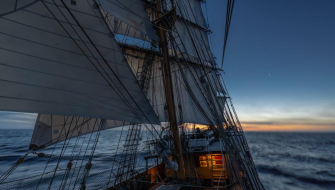 The ship at dawn with sails set.jpg