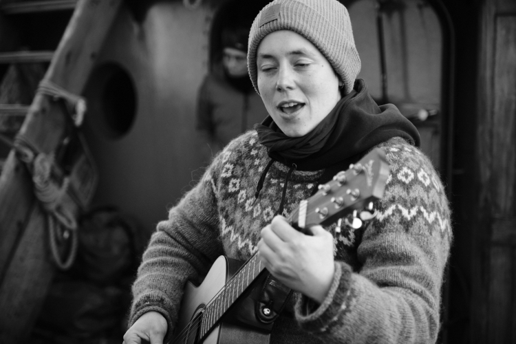 Clara singing and playing guitar