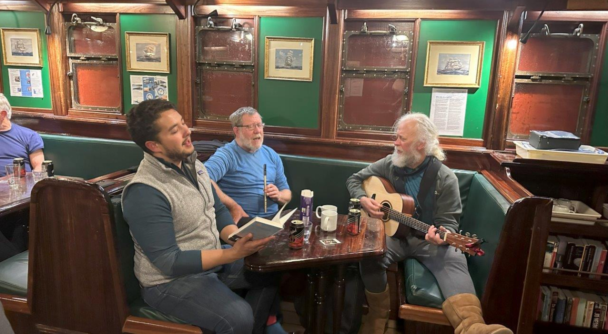 Playing guitar and singing in the deckhouse